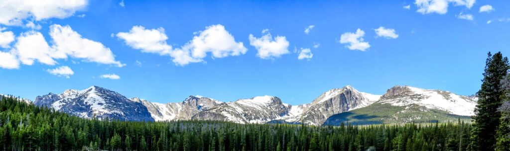 Mt. Bierstadt set agains a blue sky with small clouds in Rocky Mountain National Park